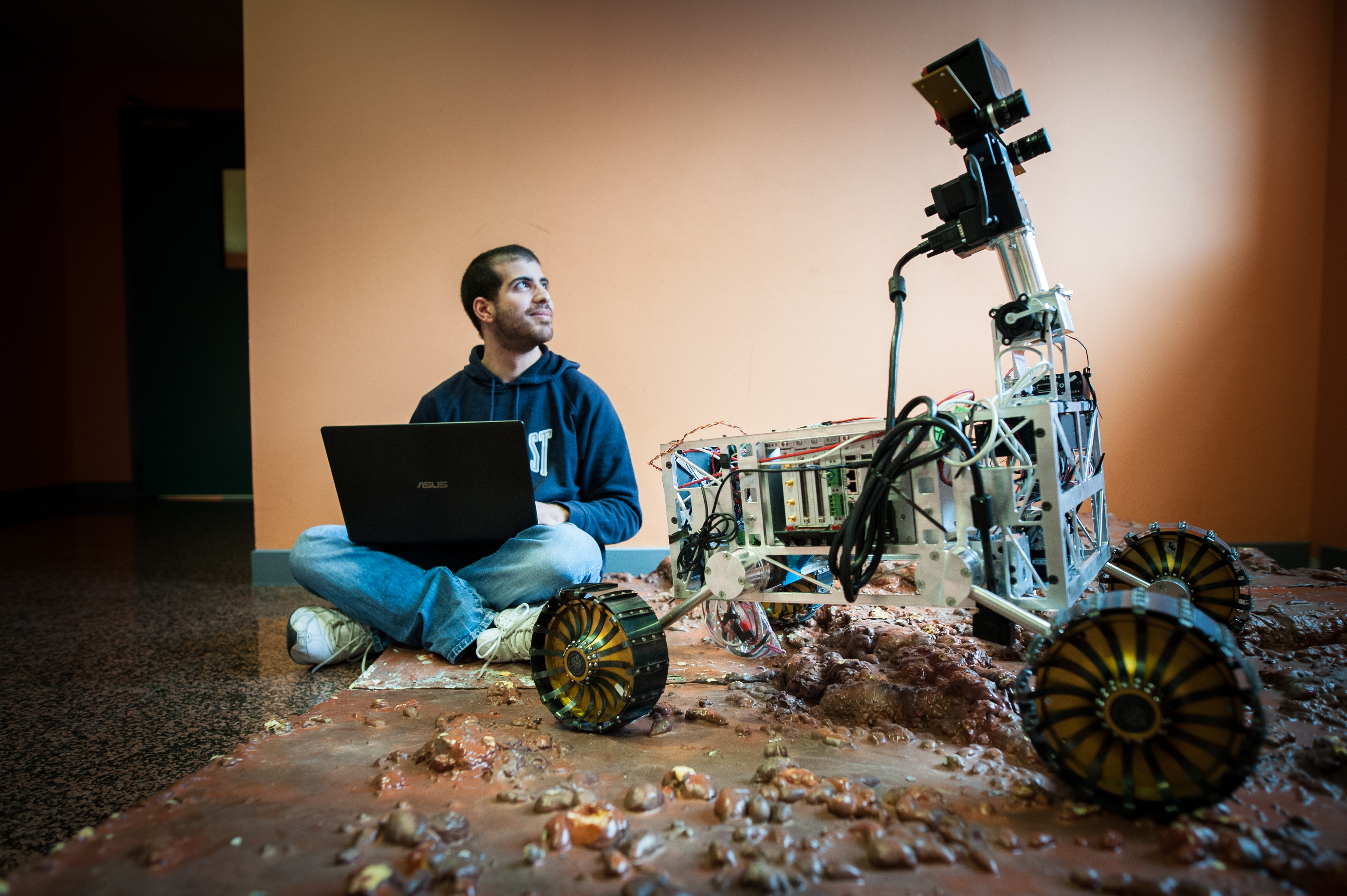 Engineer student daydreaming with his robot