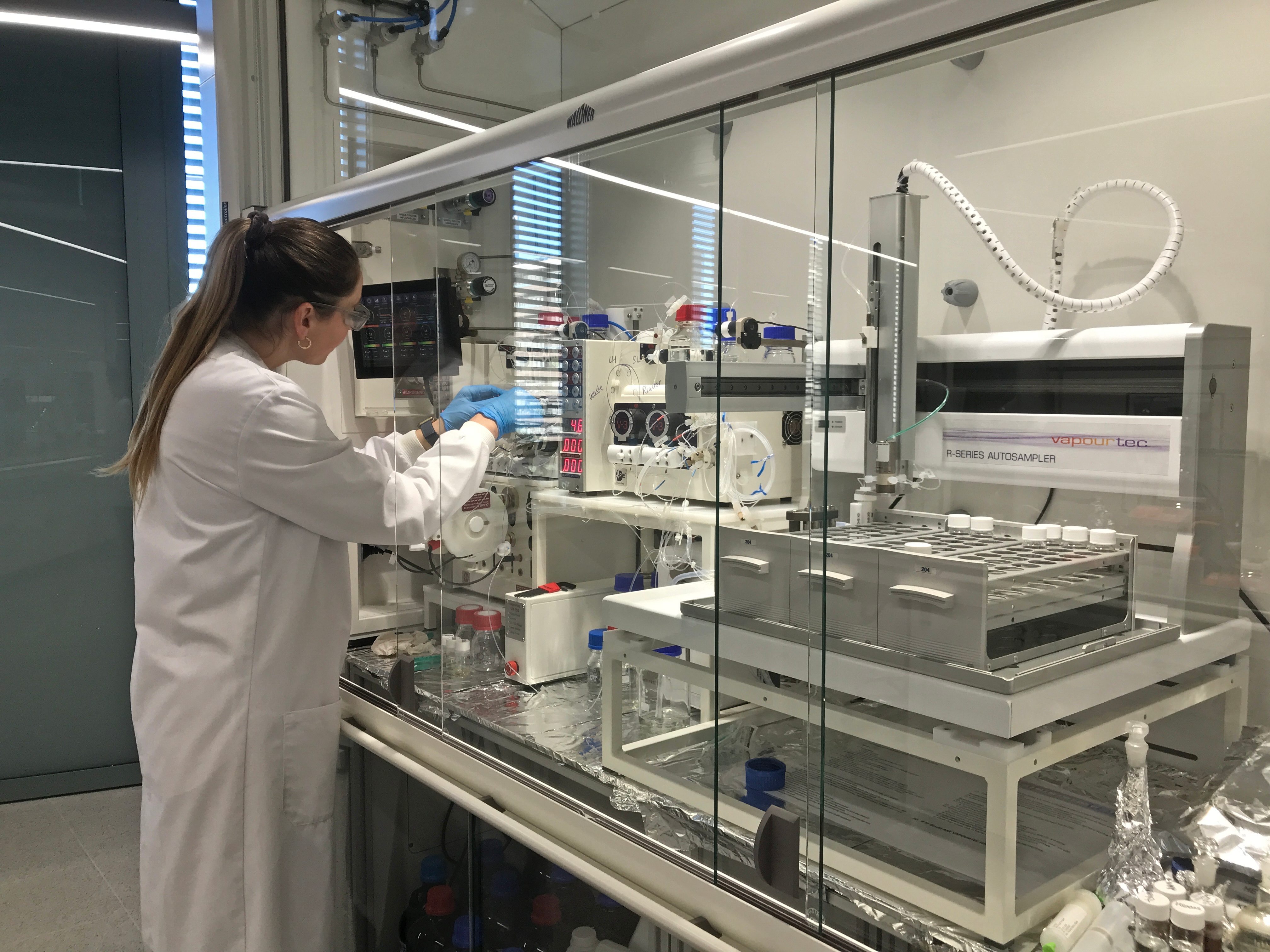 See larger image Student using a lab equipment during a research equipment